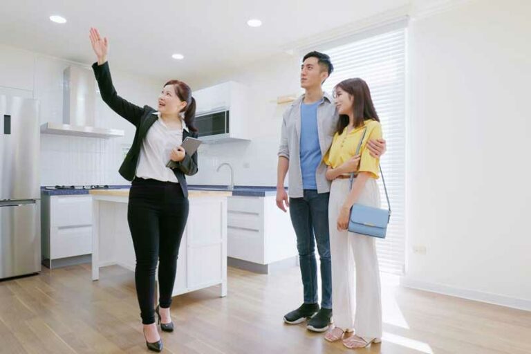 estate agent showing house to couple