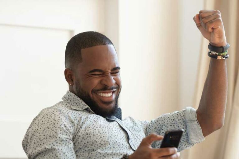 man celebrates with fist in the air