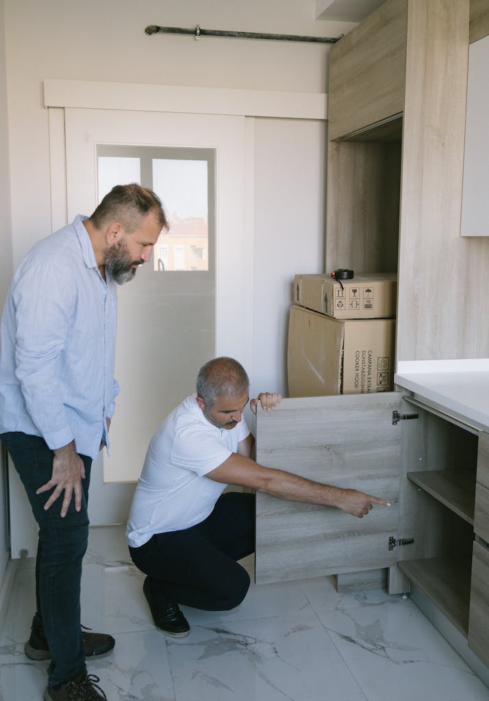 A Man Pointing inside a Cabinet